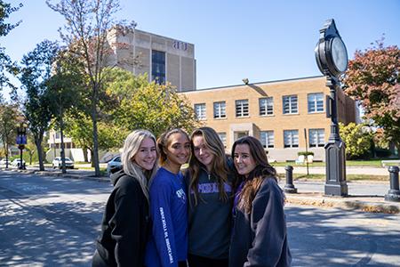 group of 4 smiling students