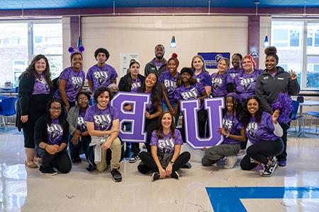 group of students wearing UB shirts holding up the letters UB